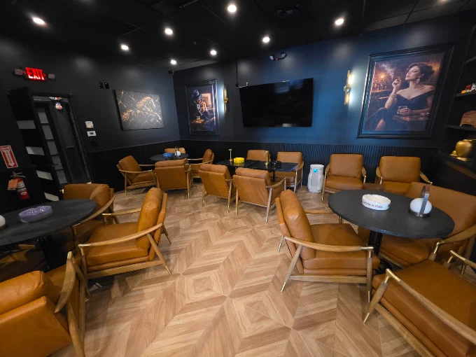Warm leather seating and dark blue walls at Caballeros Cigar Bar in Troy