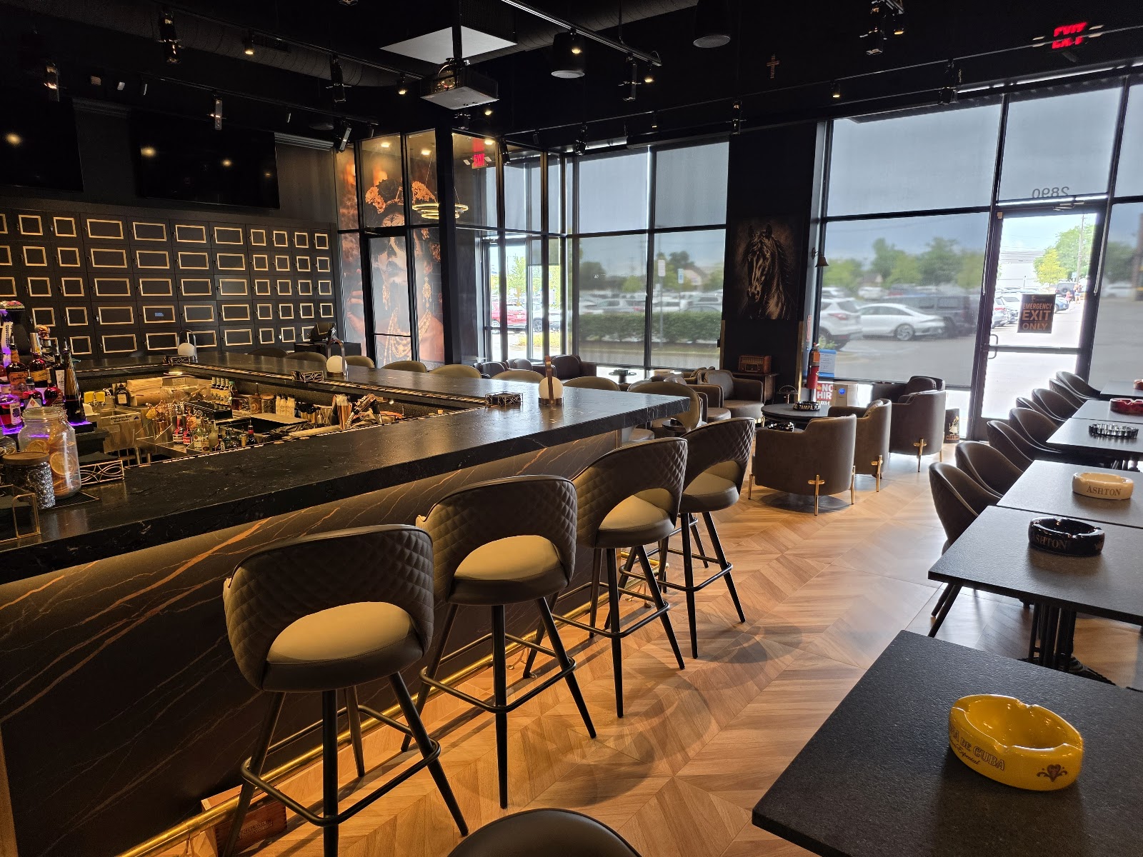 The marble bar and upholstered bar stools at Caballeros Cigar Bar & Lounge in Troy, Michigan
