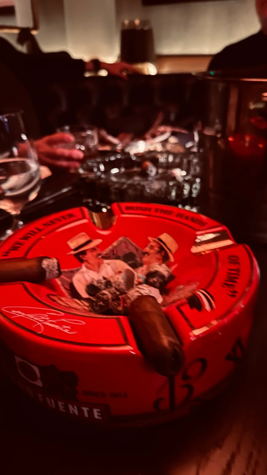 Cigars and accessories displayed on a red tabletop